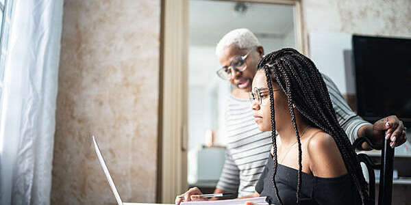 Mother and daughter studying with laptop on a online class at home