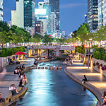 People relaxing by Cheong-Gyecheon stream in the centre of Seoul.