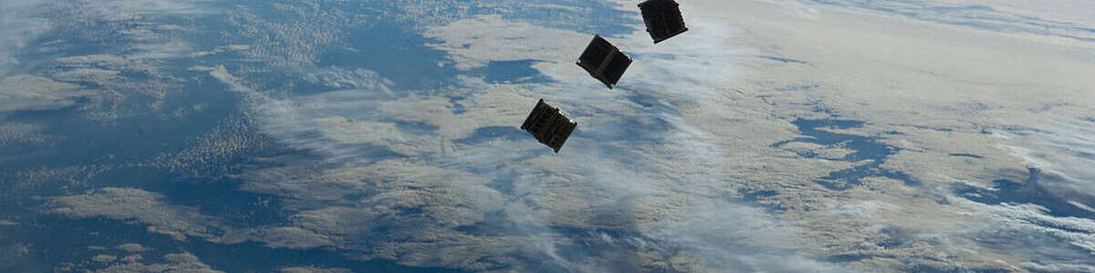 Three small deployed satellites.